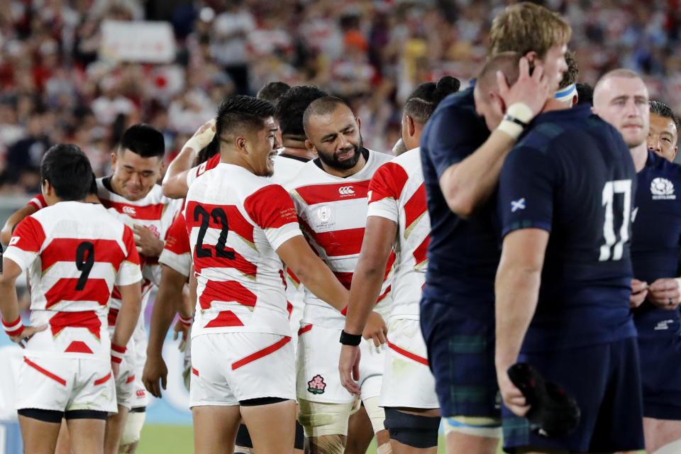 Japan's Michael Leitch, center, celebrates with teammates after winning over Scotland in the Rugby World Cup Pool A game at International Stadium in Yokohama, Japan, Sunday, Oct. 13, 2019. (AP Photo/Eugene Hoshiko)