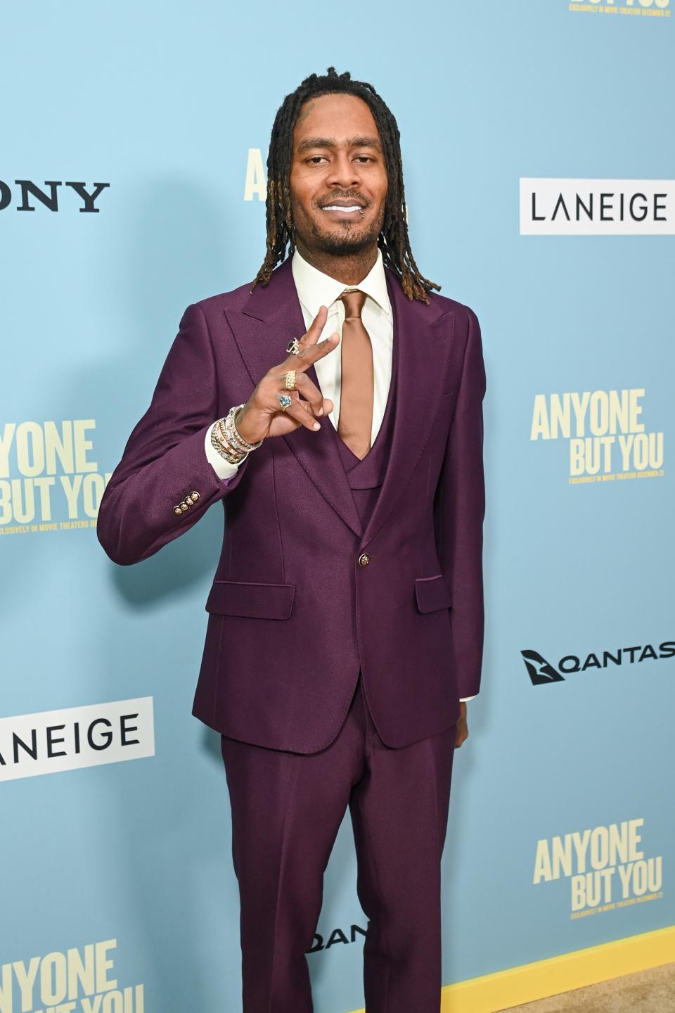 GaTa in a burgundy suit