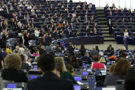 Members of Parliament applaud after Germany's Ursula von der Leyen, right, delivered her speech at the European Parliament in Strasbourg, eastern France, Tuesday July 16, 2019. Ursula von der Leyen outlined her vision and plans as Commission President. The vote, held by secret paper ballot, will take place later today. (AP Photo/Jean-Francois Badias)