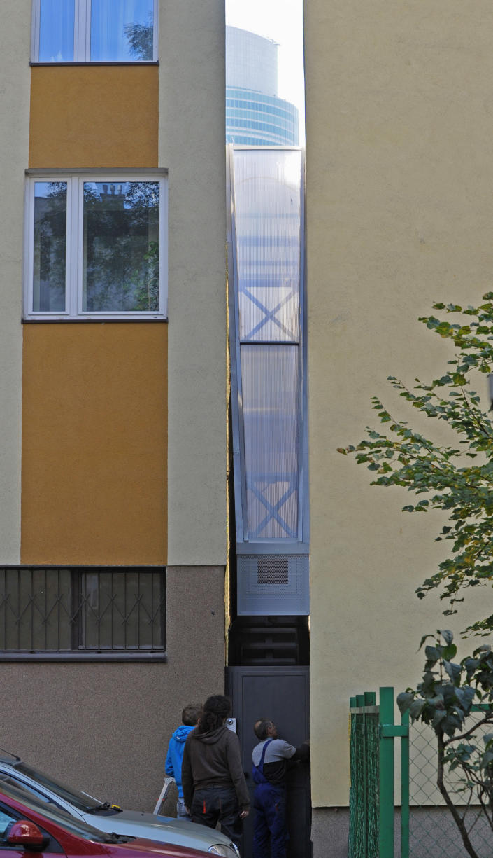 Workers adjust a gate in front of one of the world’s narrowest houses, in Warsaw, Poland, Friday, Oct. 19, 2012. The two-level “Keret’s House” is no wider than 122 centimeters (48.03 inches) and was fitted into tiny space puzzlingly left between a pre-war house and a modern apartment block of the 1960s in downtown Warsaw. It is named after Etgar Keret, an Israeli writer of Polish roots who will be the first inhabitant of this artistic project of aluminum and polycarbonate. (AP Photo/Alik Keplicz)