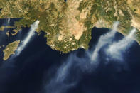 In this Tuesday, Aug. 3, 2021, Aqua satellite Moderate Resolution Imaging Spectroradiometer (MODIS) image taken in natural color and provided by NASA, several wildfires burn near the coastal towns of Marmaris, left, and Antalya, along the southern coast of Turkey. (NASA via AP)