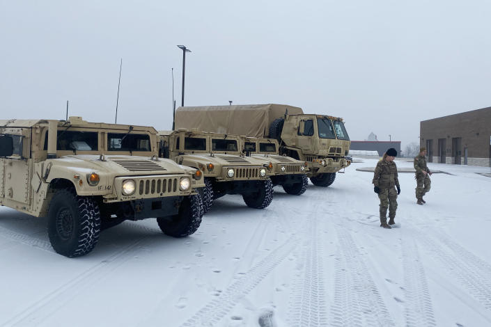 Soldiers from the 142nd Field Artillery Brigade in Lowell, Ark., prepare as inclement weather bears down on the region Monday. (Arkansas National Guard)