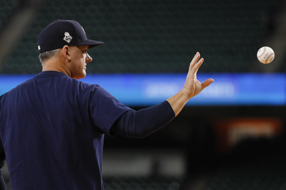 Houston Astros manager AJ Hinch catches a ball during batting practice before Game 2 of the baseball World Series against the Washington Nationals Wednesday, Oct. 23, 2019, in Houston. (AP Photo/Matt Slocum)