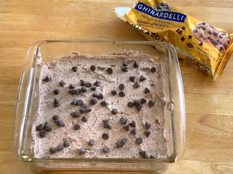 Adding chocolate chips to first layer of celebration cake