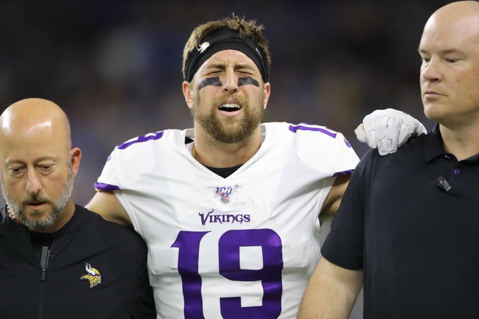 Vikings receiver Adam Thielen limps off the field after a first-quarter touchdown. (Rey Del Rio/Getty Images)