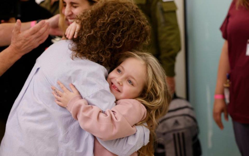 Six year-old Amelia Aloni hugs her grandmother