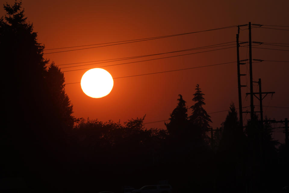 The sun is seen against a sky turned orange with smoke from wildfires as it sets, Tuesday, September 8, 2020, near Sumner, Washington, south of Seattle. / Credit: Ted S. Warren / AP