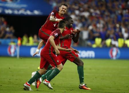 Football Soccer - Portugal v France - EURO 2016 - Final - Stade de France, Saint-Denis near Paris, France - 10/7/16 Portugal's Eder celebrates with team mates after scoring their first goal REUTERS/Kai Pfaffenbach Livepic