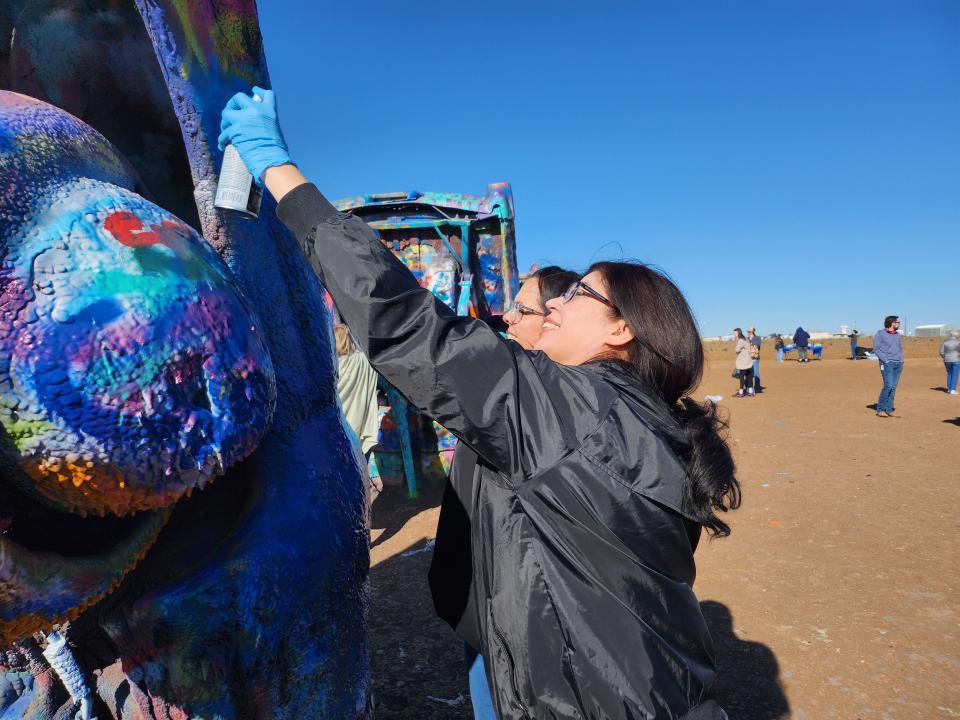 Saint Francis Ministries staff and volunteers Paint the Cadillac Ranch Blue, the official color of national Child Abuse Prevention month.
