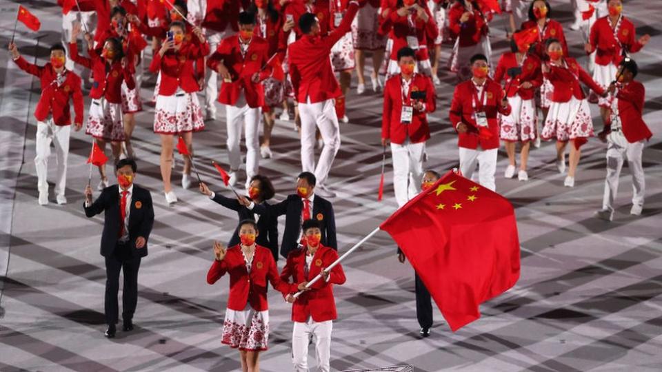 Flag bearers Ting Zhu and Shuai Zhao of Team China lead their team out during the Opening Ceremony of the Tokyo 2020 Olympic Games at Olympic Stadium on July 23, 2021 in Tokyo, Japan.