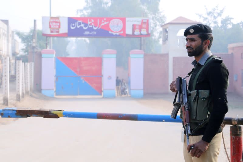 A police officer stands guard at the entrance of the Central Jail in Multan