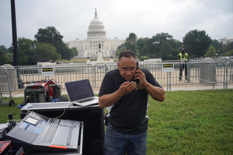 A man with a sound system, and the US Capitol in the background.