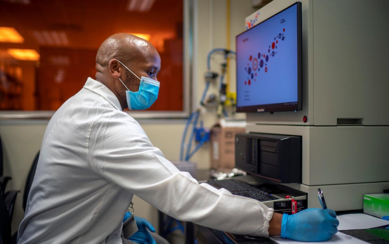 Sandile Cele, a researcher at the Africa Health Research Institute in Durban, South Africa, works on the omicron variant - AP