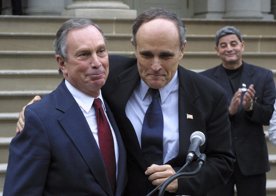 File-This photo from Saturday, Oct. 27, 2001, shows Mayor Rudolph Giuliani endorsing then Republican mayoral candidate Michael Bloomberg, left, on the steps of City Hall in New York. Saturday, Oct. 27, 2001. The Democrat-turned-Republican-turned-independent (now turned Democrat again) was unbeholden to the city's Democratic power structure or the combative law-and-order conservatism of predecessor Rudy Giuliani. (AP Photo/Robert Spencer, File)