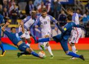 United States midfielder Graham Zusi (19) shoots the ball and scores his goal while Guatemala goalkeeper Paulo Motta (12) and defender Carlos Castrillo (13) defend in the second half of the game during the semifinal round of the 2018 FIFA World Cup qualifying soccer tournament at MAPFRE Stadium. Trevor Ruszkowski-USA TODAY Sports