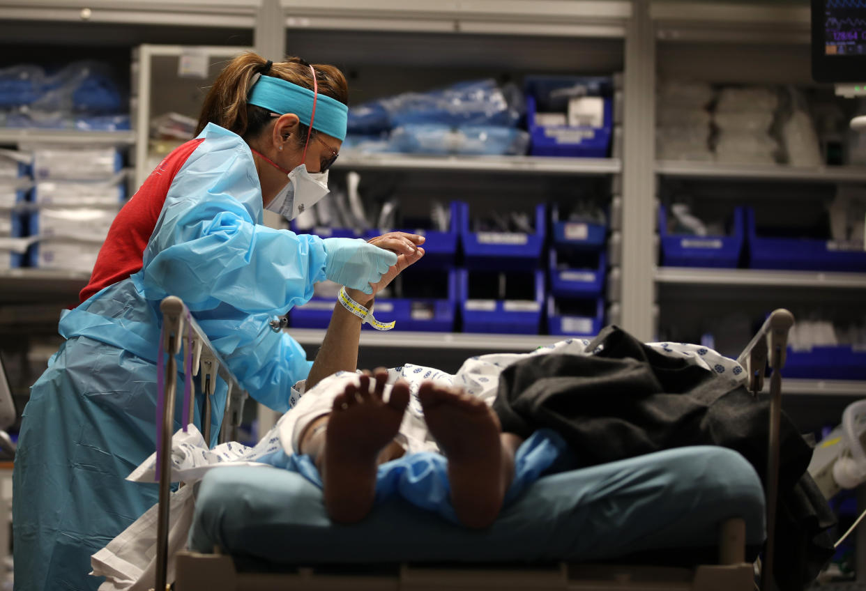 A nurse evaluates a patient with COVID-19 who was just been admitted to the emergency room at Regional Medical Center in San Jose, California. (Photo: Justin Sullivan via Getty Images)