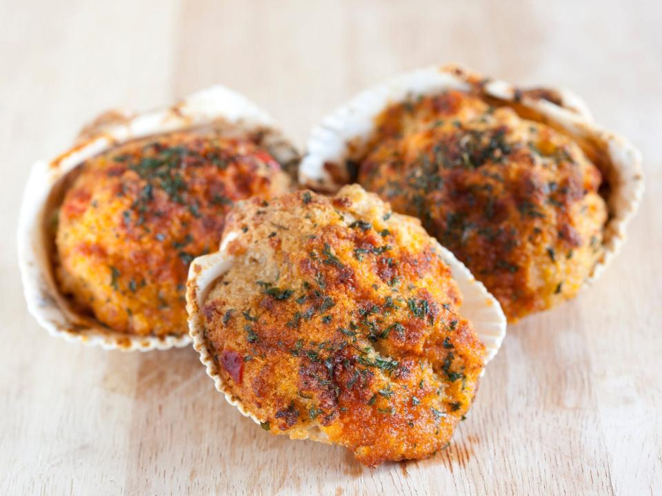 baked stuffed clams on a wood background