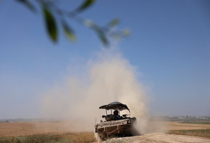 Israeli soldiers ride in a military vehicle near the Israel-Gaza border