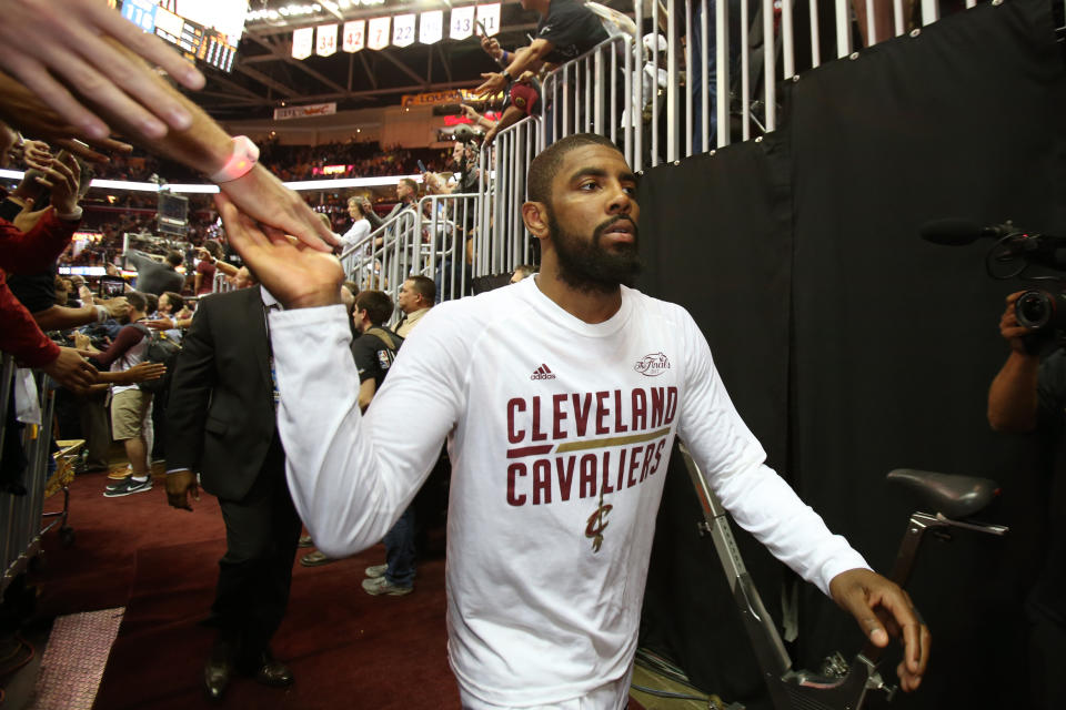 Kyrie Irving high-fives Cavaliers fans after Game 4 of the 2017 NBA Finals, which would be his final home game in Cleveland. (Getty)
