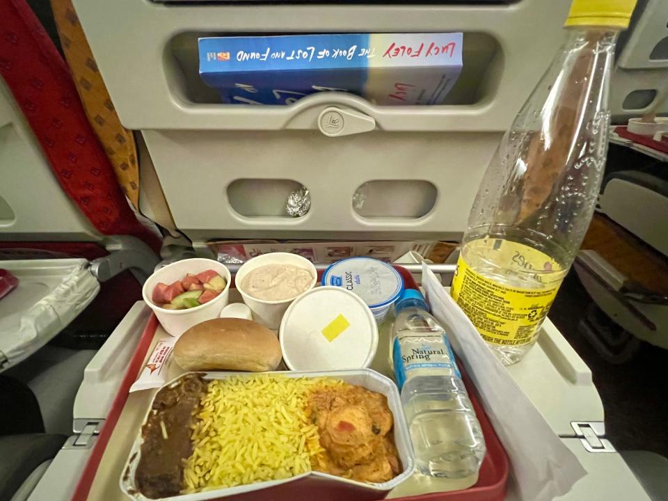 The dinner of chicken and veggies on a tray.