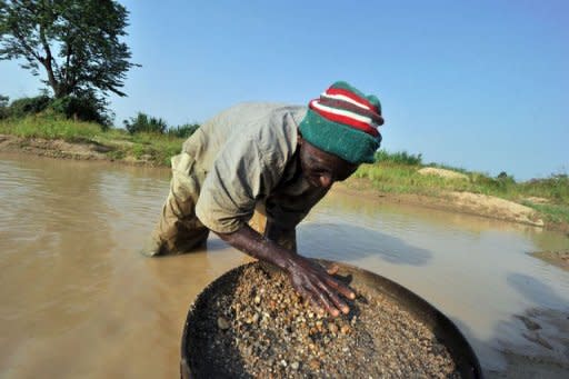 A diamond prospector filters earth from a river in April in Koidu, the capital of the diamond-rich Kono district, in eastern Sierra Leone, some 250 km east from Freetown. Small-scale artisanal mining has sustained this area since diamonds were discovered in 1930, and it was here that the 968.9-carat Star of Sierra Leone was found in 1972 -- the largest alluvial diamond ever found