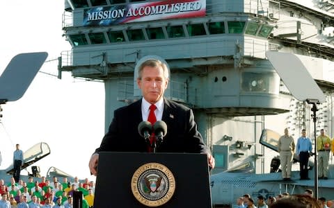 In this May 2, 2003 file photo, President George W. Bush declares the end of major combat in Iraq as he speaks aboard the aircraft carrier USS Abraham Lincoln off the California coast - Credit: AP