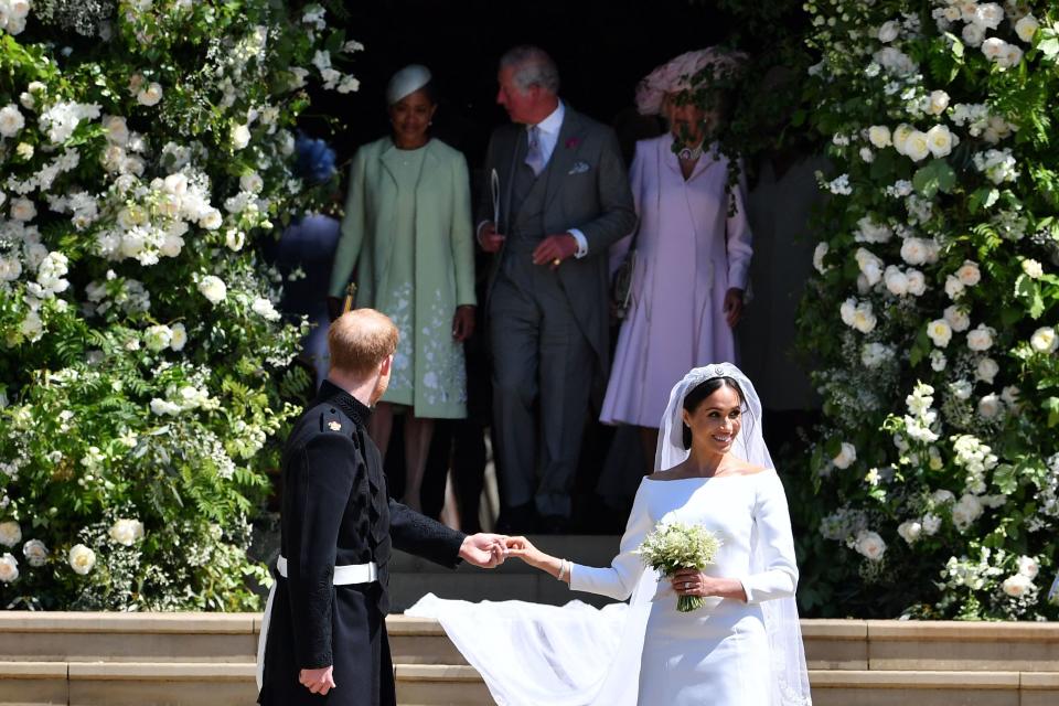 Harry turns around to find his father Charles taking good care of Meghan's mom.&nbsp;