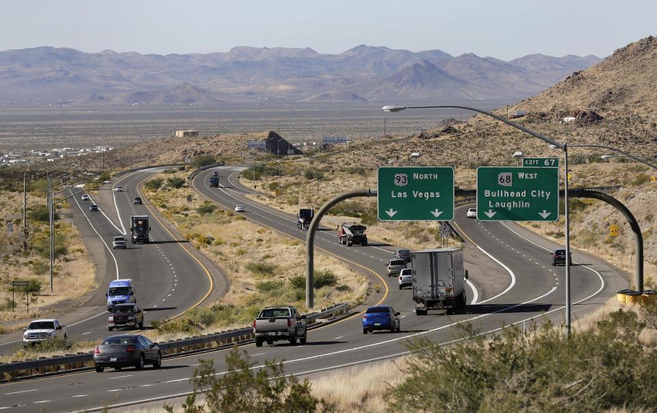 In this Friday, Nov. 8, 2013 photo, motorists head northbound toward Las Vegas on U.S. Highway 93, near Kingman, Ariz. Supporters of proposals to build an interstate highway connecting Phoenix and Las Vegas say an interstate would create a Los Angeles-Phoenix-Las Vegas “megaregion” and open a trade route from Mexico to Pacific Ocean ports and Canada. (AP Photo/Julie Jacobson)