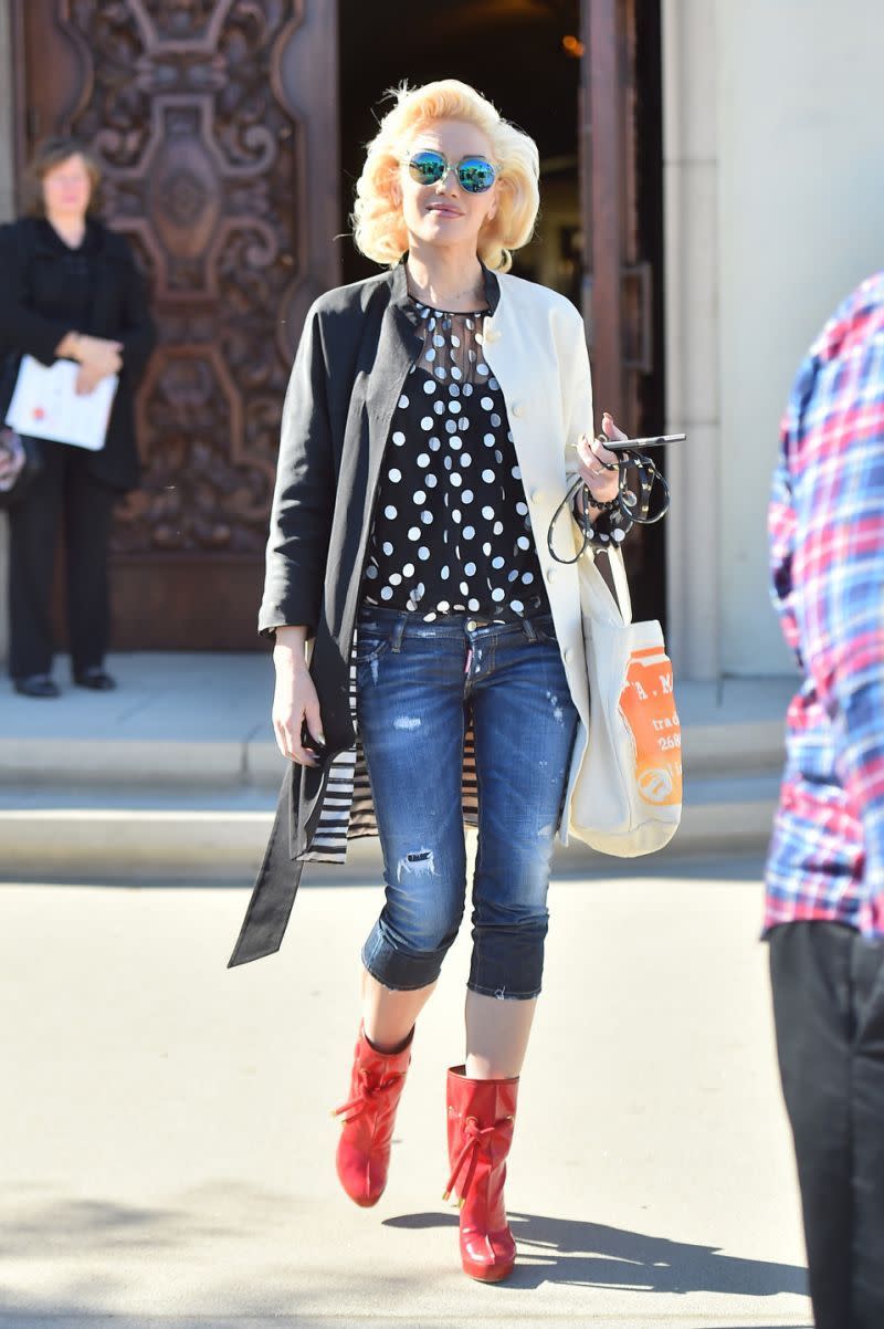 Gwen Stefani in denim capris, red boots & a black and white jacket. 