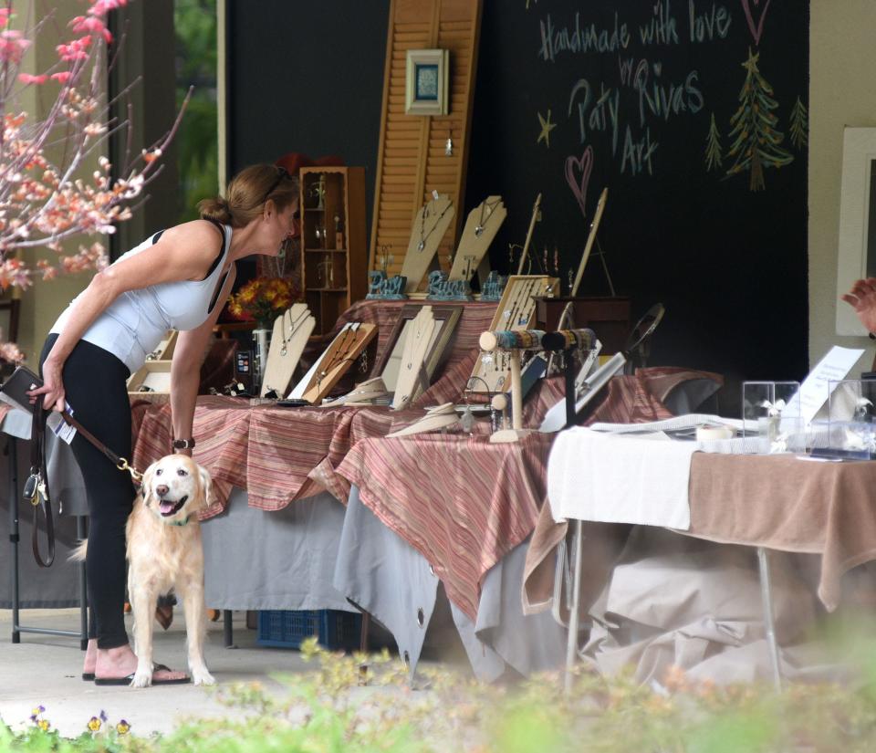 A patrons looks over some of the art during the 23rd annual Art in the Arboretum at the New Hanover County Arboretum in 2018.