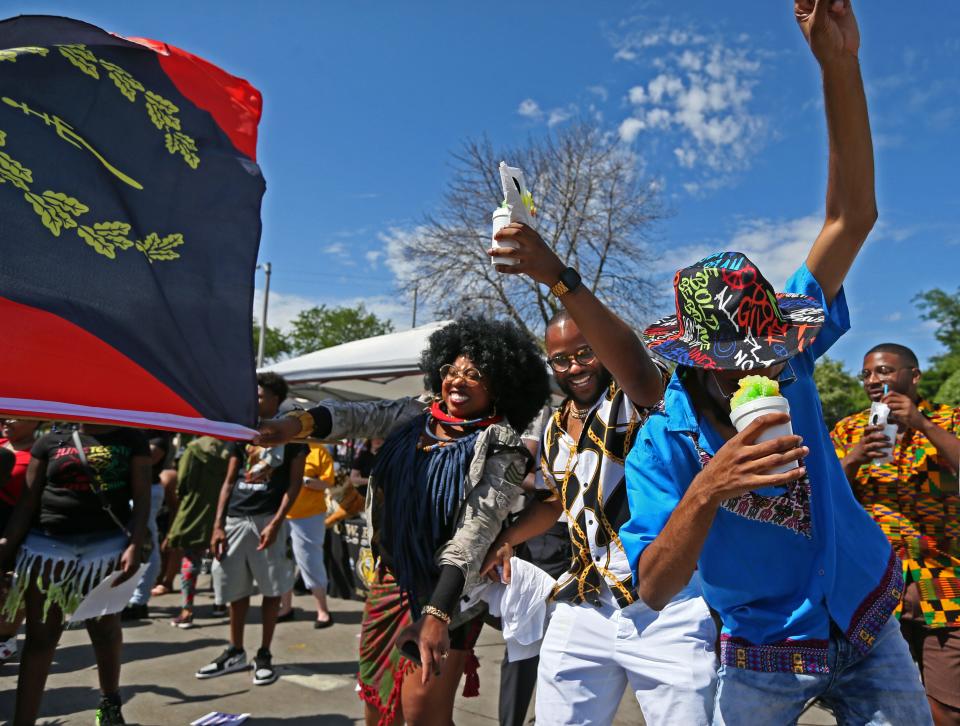 Jerrae Govani, left, DeJohn Smith and James Kennedy, right, dance to the song of James Brown, “Say it loud, I’m Black and I'm proud” that was being played by one of the cars in the parade at Juneteenth on Sunday, June 19, 2022 along Martin Luther King Jr. Drive in Milwaukee. This years marks the first year that Juneteenth is a national holiday.