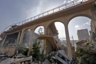 <p>This picture taken on April 14, 2018 shows the wreckage of a building described as part of the Scientific Studies and Research Center (SSRC) compound in the Barzeh district, north of Damascus, during a press tour organised by the Syrian information ministry. (Photo: Louai Beshara/AFP/Getty Images) </p>