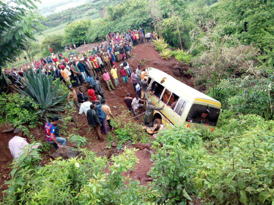 <p>Residents gather at the scene of an accident that killed schoolchildren, teachers and a minibus driver at the Rhota village along the Arusha-Karatu highway in Tanzania’s northern tourist region of Arusha, May 6, 2017. (Photo: Emmanuel Herman/Reuters) </p>