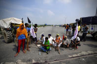 Protesting farmers gather at Singhu, outskirts of New Delhi, India, Monday, Sept.27, 2021. Thousands of Indian farmers Monday blocked traffic on major roads and railway tracks outside of the nation's capital, calling on the government to rescind agricultural laws that they say will shatter their livelihoods. The farmers called for a nation-wide strike to mark one year since the legislation was passed, marking a return to protests that began over a year ago. (AP Photo/Manish Swarup)