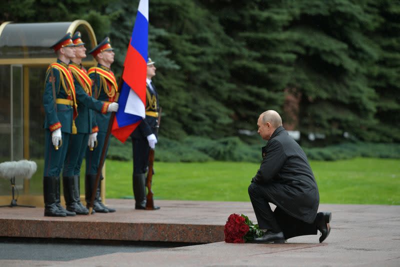 Russian President Vladimir Putin takes part in a flower-laying ceremony at the Tomb of the Unknown Soldier on Victory Day in central Moscow