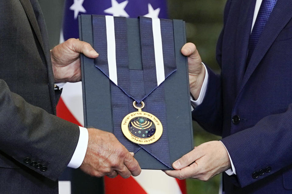 President Joe Biden, left, receives the Israeli Presidential Medal of Honor from Israeli President Isaac Herzog, Thursday, July 14, 2022, in Jerusalem. (AP Photo/Evan Vucci)