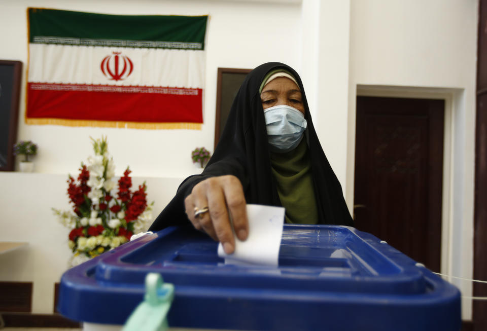 An Iranian woman casts his vote during the presidential election at a polling station inside the Iranian consulate in Karbala, Iraq, Friday, June 18, 2021. Iran began voting Friday in a presidential election tipped in the favor of a hard-line protege of Supreme Leader Ayatollah Ali Khamenei, fueling public apathy and sparking calls for a boycott in the Islamic Republic.(AP Photo/Hadi Mizban)