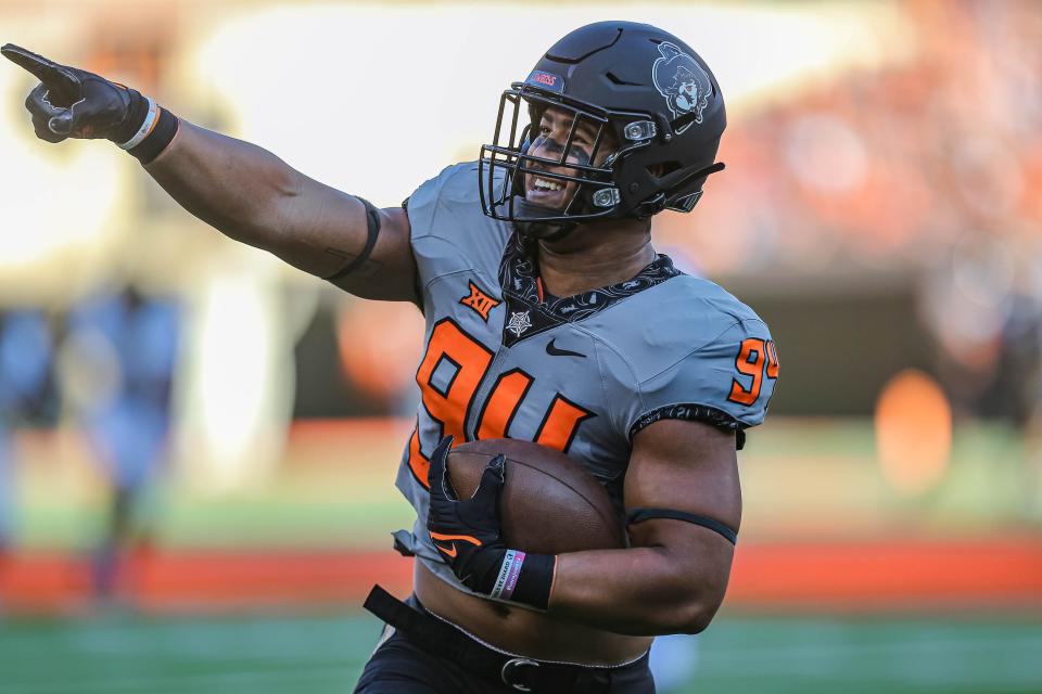 Oklahoma State's Trace Ford (94) points to fan as he scores a touchdown against Arkansas-Pine Bluff on Sept. 17 in Stillwater.