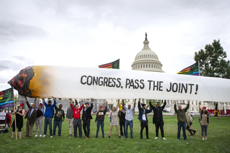 Marijuana activists hold up a 51-foot inflatable joint during a rally on Oct. 8, 2019, at the U.S. Capitol to call on Congress to pass cannabis reform legislation. (Photo by Caroline Brehman/CQ-Roll Call, Inc via Getty Images)
