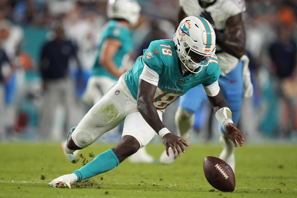 Miami Dolphins quarterback Tyler Huntley (18) goes after the ball after a bad snap against the Titans. (AP Photo/Rebecca Blackwell)