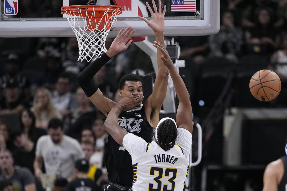 San Antonio Spurs center Victor Wembanyama is hit in the face as he blocks Indiana Pacers center Myles Turner (33) during the first half of an NBA basketball game in San Antonio, Sunday, March 3, 2024. (AP Photo/Eric Gay)