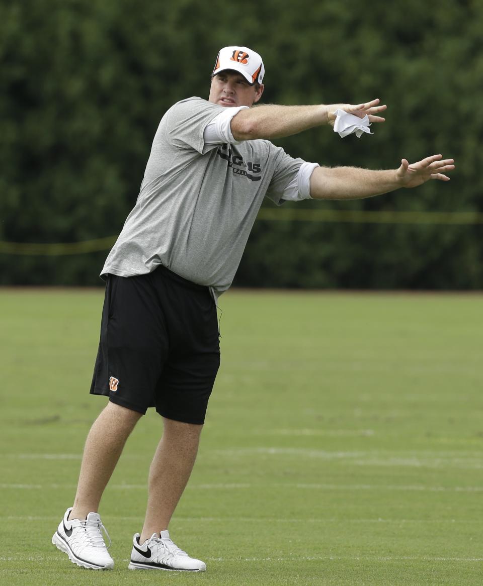 FILE - In this July 27, 2013 file photo, Cincinnati Bengals offensive coordinator Jay Gruden demonstrates for player during practice at the NFL football team's training camp, in Cincinnati. Jay Gruden has agreed to become the head coach of the Washington Redskins. The Redskins confirmed Thursday, Jan. 9, 2014, that Gruden has accepted the job and will be introduced at an afternoon news conference. (AP Photo/Al Behrman, File)