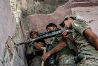 <p>An Iraqi Special Operation Forces (ISOF) sniper team in the Islamic State occupied Old City district where heavy fighting continues on July 8, 2017 in Mosul, Iraq. (Photo: Martyn Aim/Corbis via Getty Images) </p>