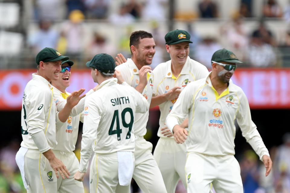 Seen here, Aussie players celebrate during an incredible opening session in the first Ashes Test at the Gabba.