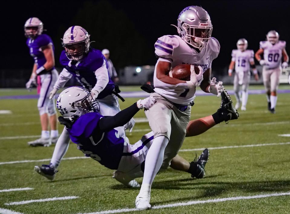 Bloomington South’s D’Andre Black (1) escapes the tackle attempt of Seymour’s Will Mahoney (35) on his way to scoring a touchdown during the IHSAA sectional championship football game at Seymour on Friday, Nov. 3, 2023.