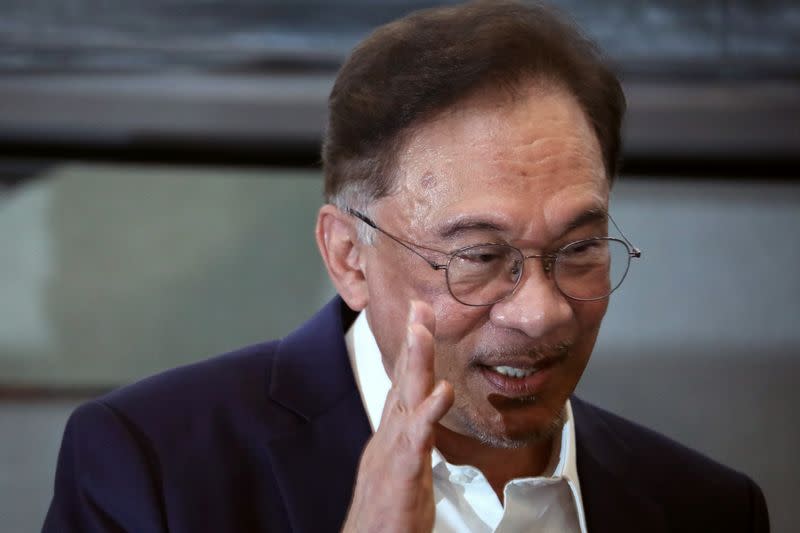 Malaysia opposition leader Anwar Ibrahim waves after a news conference in Kuala Lumpur