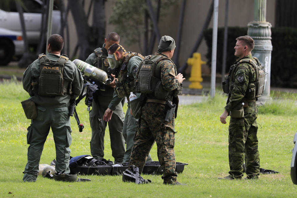 Honolulu police gather near the scene of a shooting near Diamond Head State Monument on Sunday, Jan. 19, 2020, in Honolulu. (AP Photo/Marco Garcia)