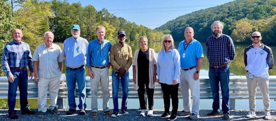 Some of the officials who recently visited the small modular reactor Clinch River Site are pictured at the bridge at the entrance. From left: Andy Wallace and Jerry Shattuck, Anderson County Economic Development; County Commissioner Stephen Verran, TVA Senior Vice President Bob Deacy, County Commissioner Anthony Allen, Anderson County Mayor Terry Frank, County Commissioner Denise Palmer, Property Assessor Johnny Alley, County Commissioner Josh Anderson, and Anderson County Emergency Management Agency Director Brice Kidwell.