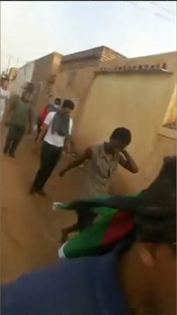 Protesters flee along side streets away from a sit-in, after security forces tried to disperse them, in central Khartoum, Sudan in this still frame taken from June 3, 2019 social media video