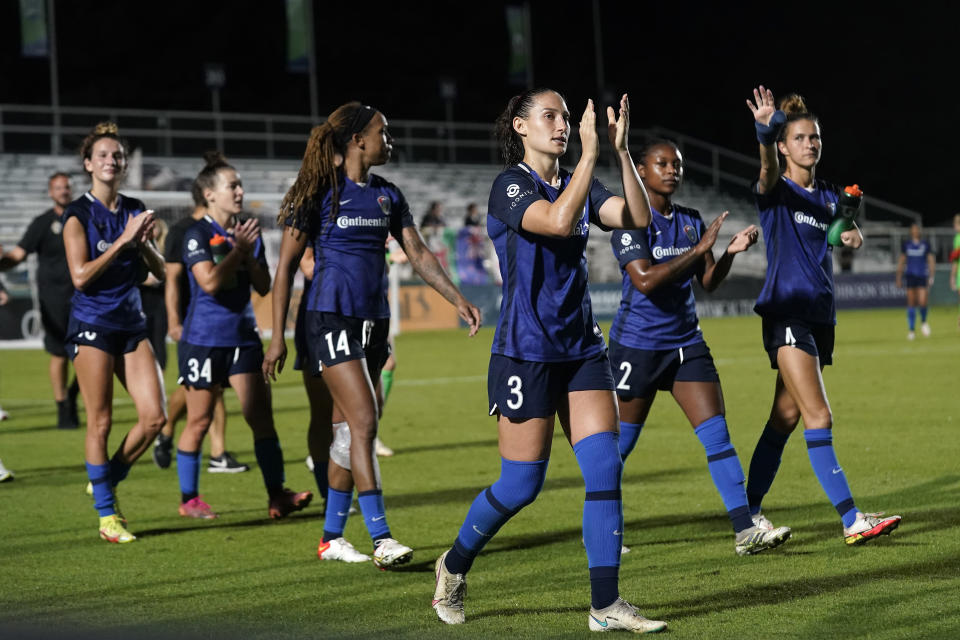 North Carolina Courage defender Kaleigh Kurtz (3) and teammates greet fans following an NWSL soccer match against Racing Louisville FC in Cary, N.C., Wednesday, Oct. 6, 2021. (AP Photo/Gerry Broome)
